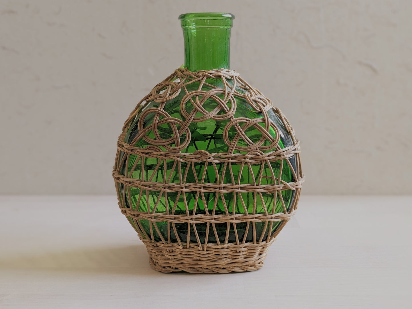 Vintage green glass sake bottle with weavings