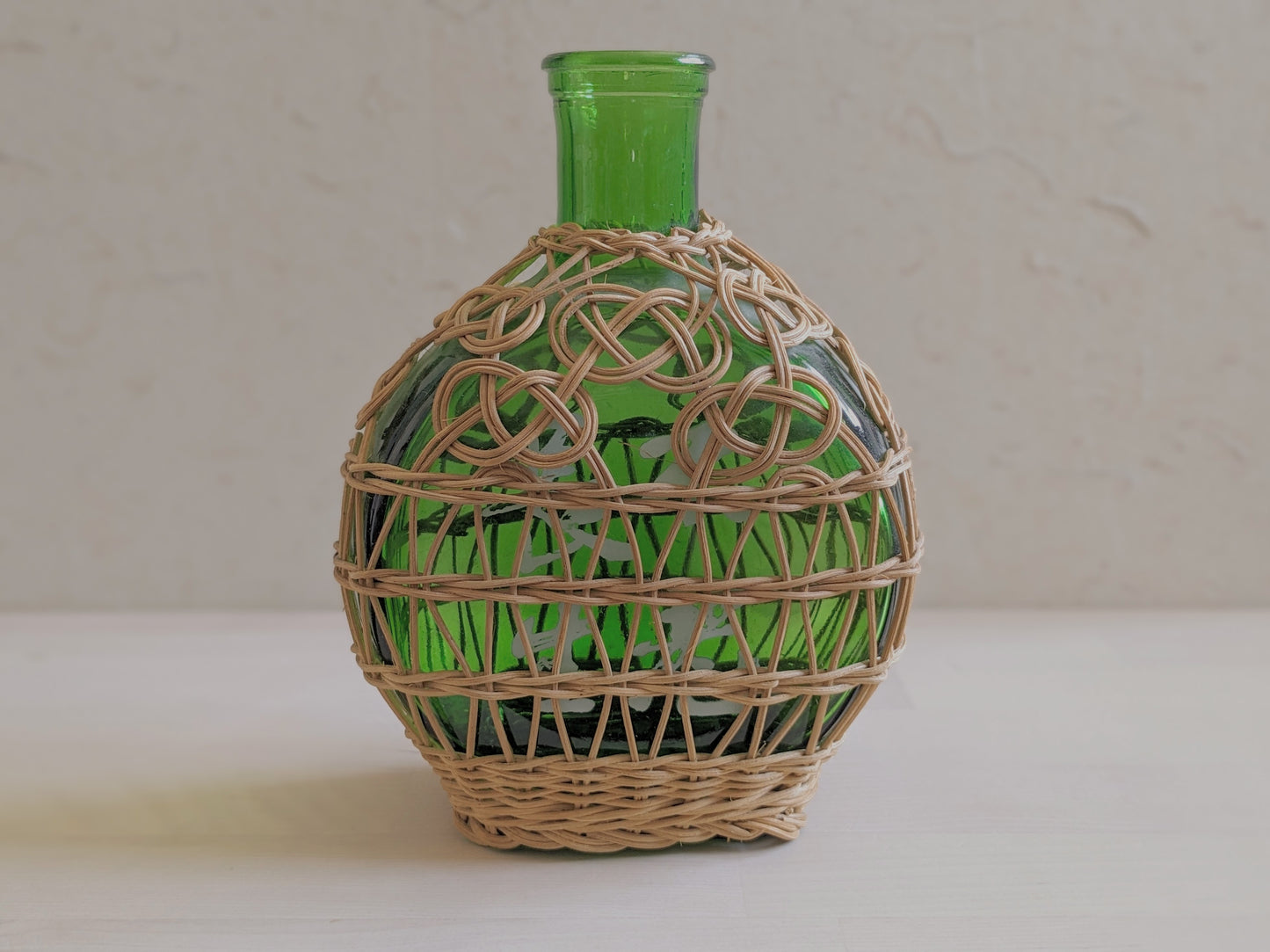 Vintage green glass sake bottle with weavings