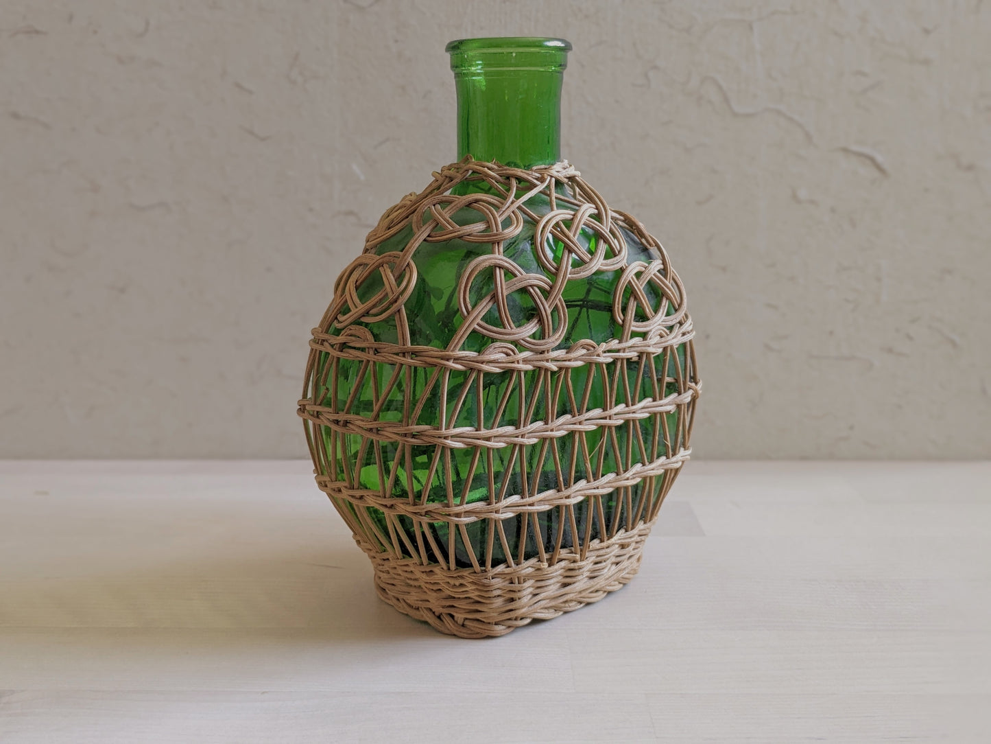 Vintage green glass sake bottle with weavings