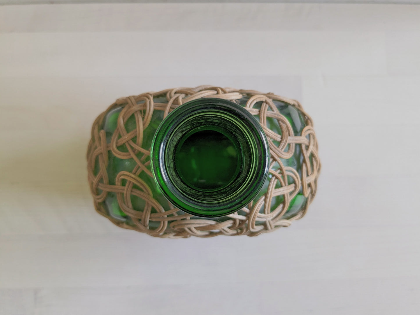 Vintage green glass sake bottle with weavings