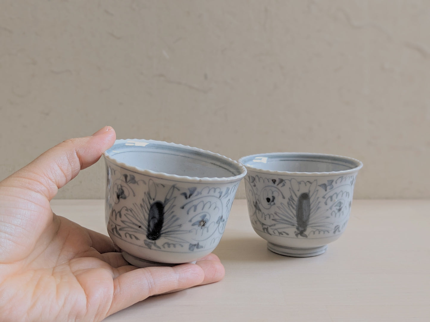 Guinomi sake cup with Celadon glaze and hand-painted arabesque, set of two