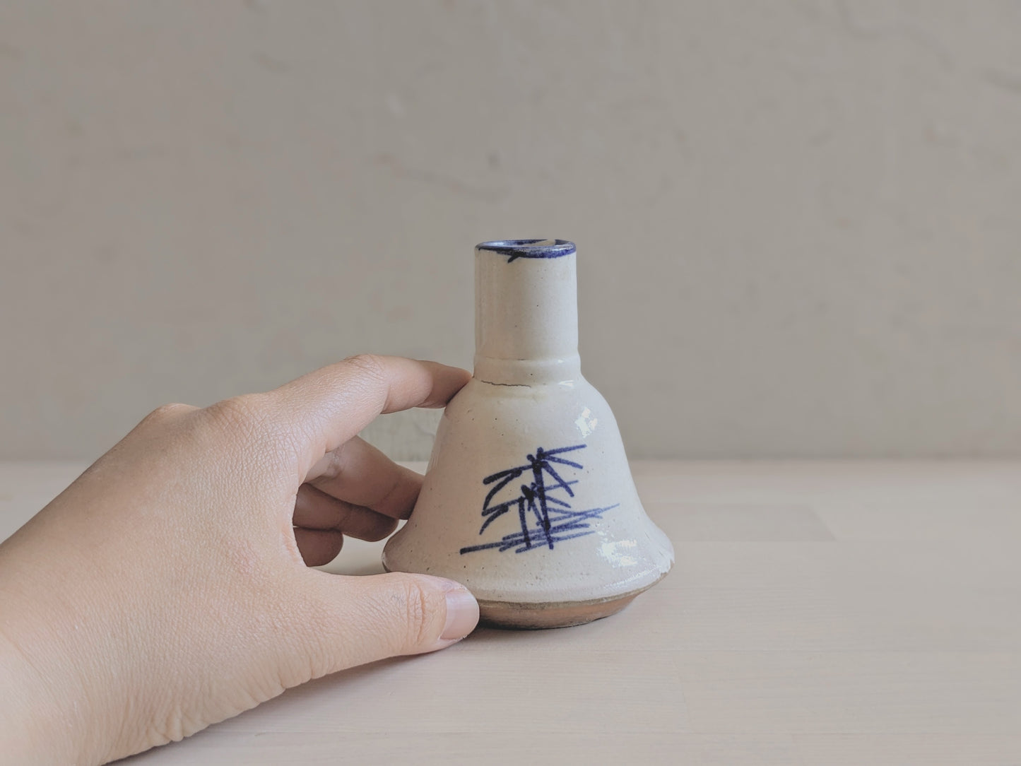 Bell-shaped pottery vase with abstract hand-writhing