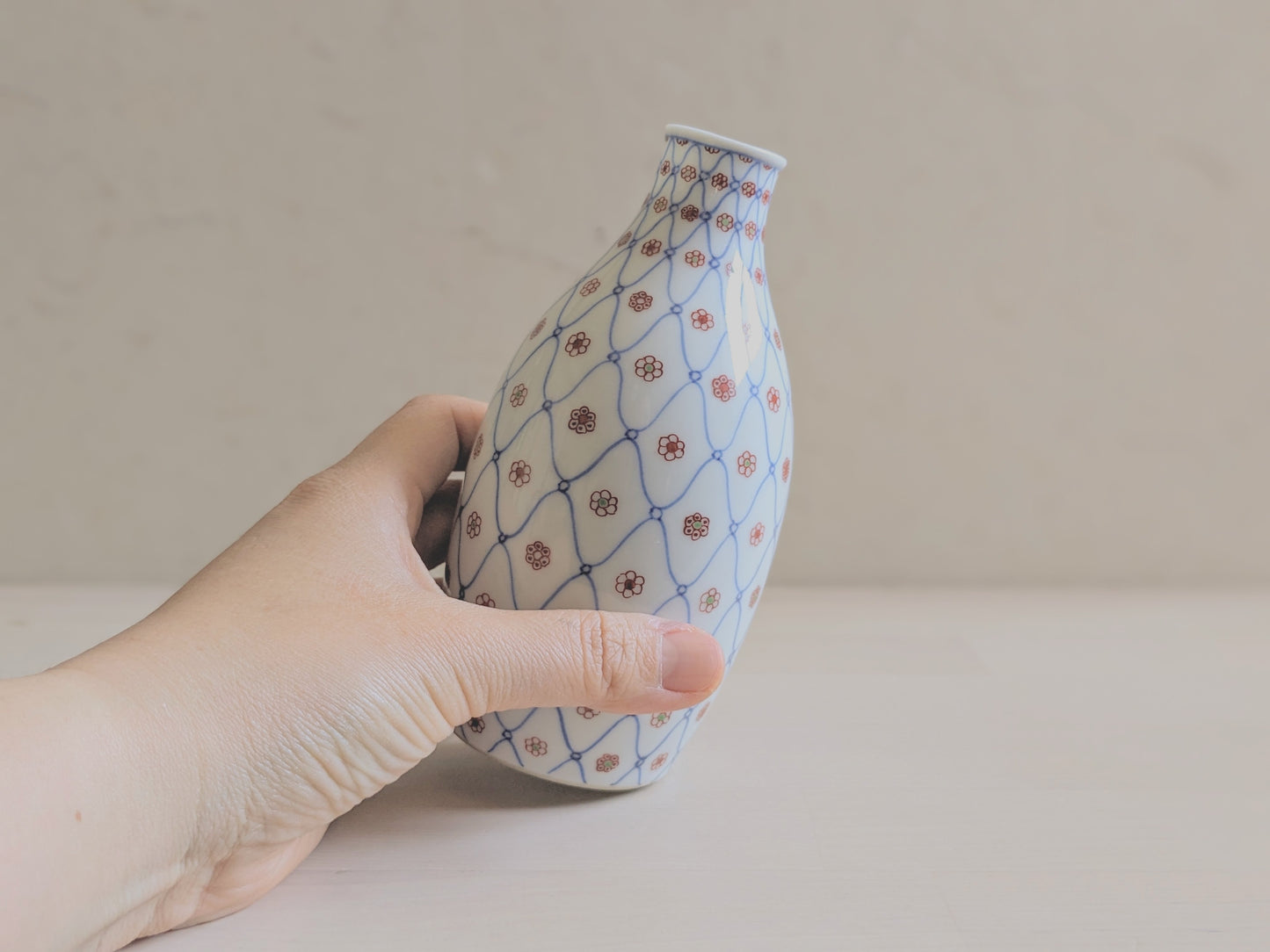 Vintage sake bottle with fishnet and flower pattern