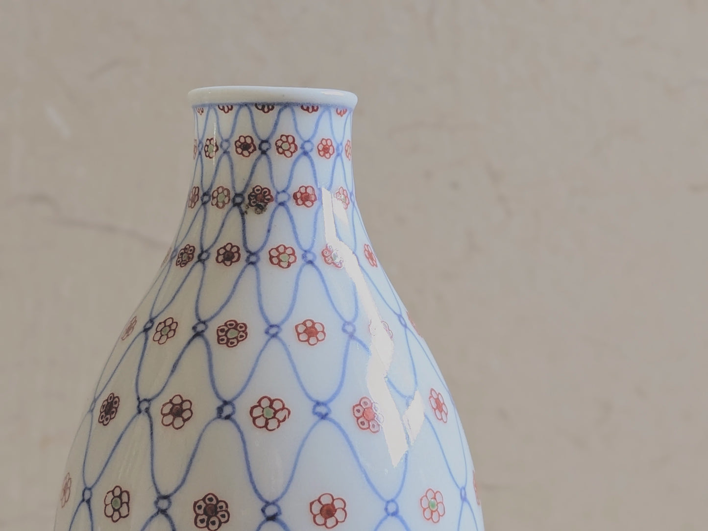 Vintage sake bottle with fishnet and flower pattern