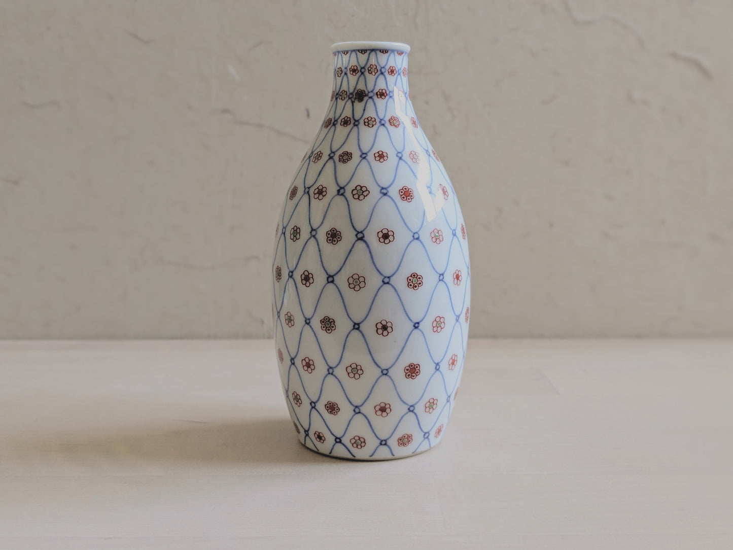 Vintage sake bottle with fishnet and flower pattern